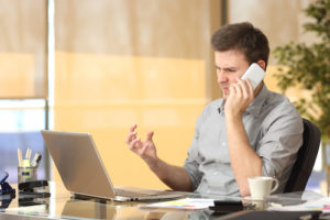 frustrated man at work on phone