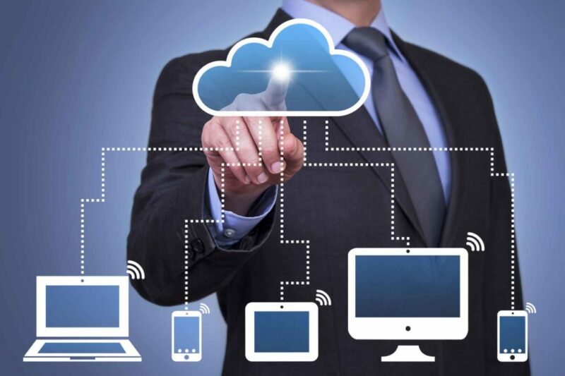 Man touching cloud infographic with desktop, laptop and smart phone devices